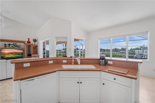 2871 Bracci Dr, Saint James City, FL 33956 - kitchen with dishwasher, a sink, lofted ceiling, open floor plan, and white cabinetry