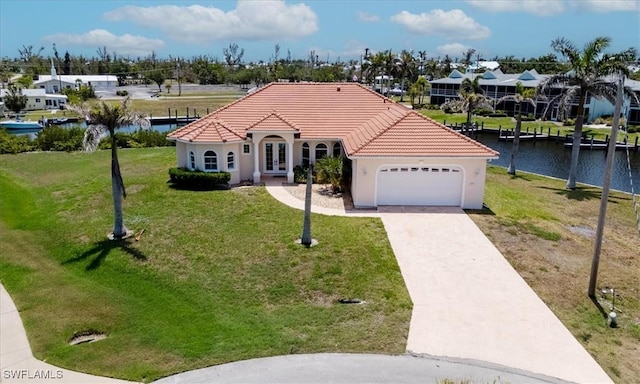 2871 Bracci Dr, Saint James City, FL 33956 - mediterranean / spanish-style home with french doors, a tiled roof, a garage, a front yard, and driveway