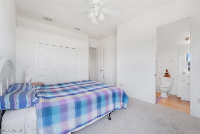 2871 Bracci Dr, Saint James City, FL 33956 - carpeted bedroom with a closet, connected bathroom, and ceiling fan