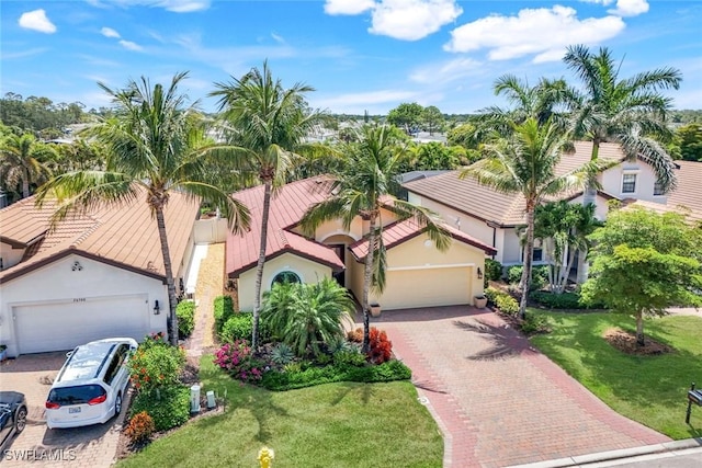26304 Prince Pierre Way, Bonita Springs, FL 34135 - view of front of property featuring an attached garage, decorative driveway, a front lawn, and stucco siding