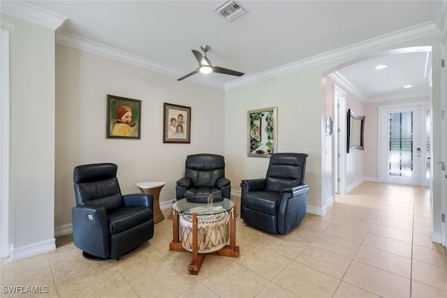 26304 Prince Pierre Way, Bonita Springs, FL 34135 - living area featuring arched walkways, ornamental molding, light tile patterned floors, baseboards, and a ceiling fan