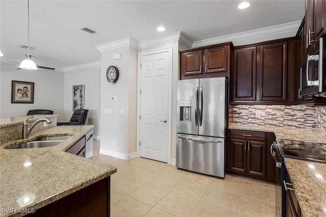 26304 Prince Pierre Way, Bonita Springs, FL 34135 - kitchen with stainless steel appliances, a sink, ornamental molding, backsplash, and light stone counters