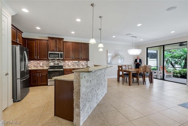 26304 Prince Pierre Way, Bonita Springs, FL 34135 - kitchen featuring appliances with stainless steel finishes, tasteful backsplash, light tile patterned floors, crown molding, and light stone countertops