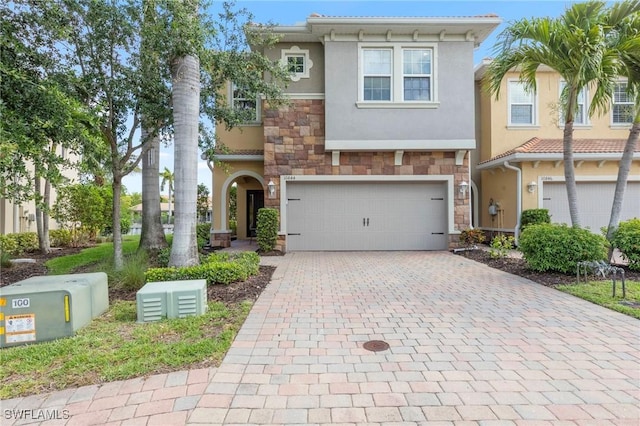 10844 Alvara Point Dr, Bonita Springs, FL 34135 - view of front of house with stone siding, stucco siding, decorative driveway, and a garage