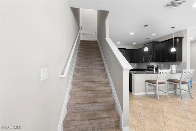 10844 Alvara Point Dr, Bonita Springs, FL 34135 - stairway featuring recessed lighting, tile patterned floors, and baseboards