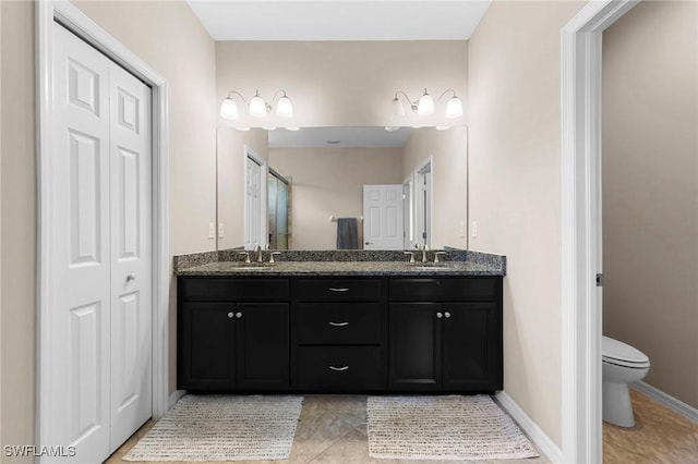 10844 Alvara Point Dr, Bonita Springs, FL 34135 - bathroom featuring double vanity, toilet, tile patterned flooring, and a closet