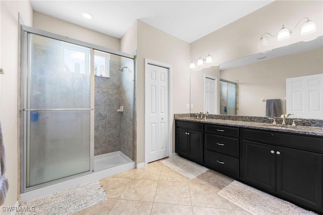10844 Alvara Point Dr, Bonita Springs, FL 34135 - full bath with double vanity, a shower stall, and tile patterned flooring
