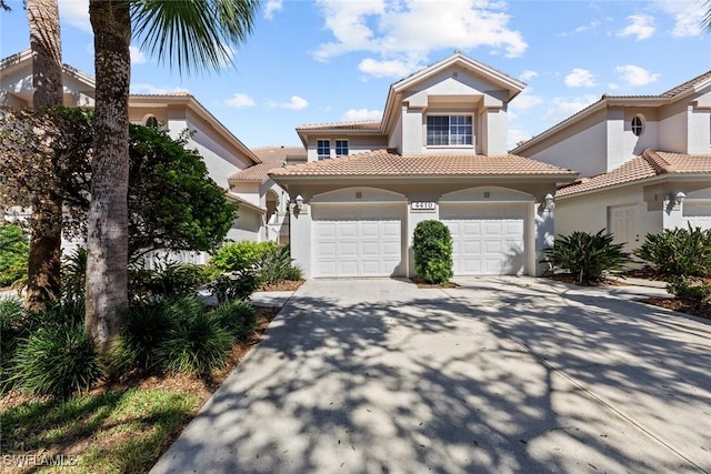 4410 Riverwatch Dr Unit 102, Bonita Springs, FL 34134 - mediterranean / spanish home featuring a tile roof, driveway, stucco siding, and a garage