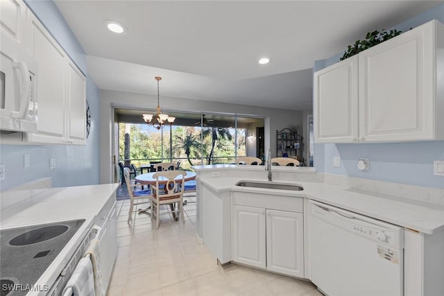 4410 Riverwatch Dr Unit 102, Bonita Springs, FL 34134 - kitchen with white appliances, a sink, white cabinetry, and recessed lighting