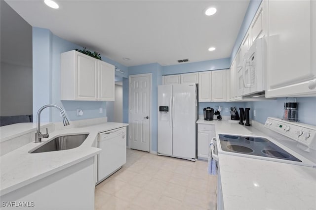 4410 Riverwatch Dr Unit 102, Bonita Springs, FL 34134 - kitchen featuring white appliances, a sink, white cabinets, light stone counters, and recessed lighting