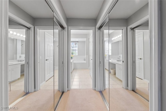4410 Riverwatch Dr Unit 102, Bonita Springs, FL 34134 - hall with light tile patterned flooring and light colored carpet