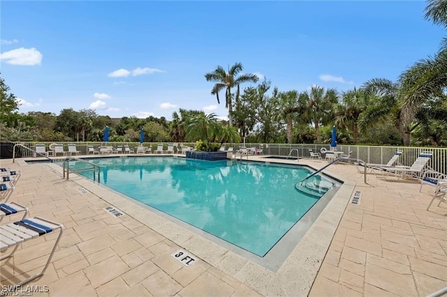 4410 Riverwatch Dr Unit 102, Bonita Springs, FL 34134 - community pool featuring a patio and view of scattered trees