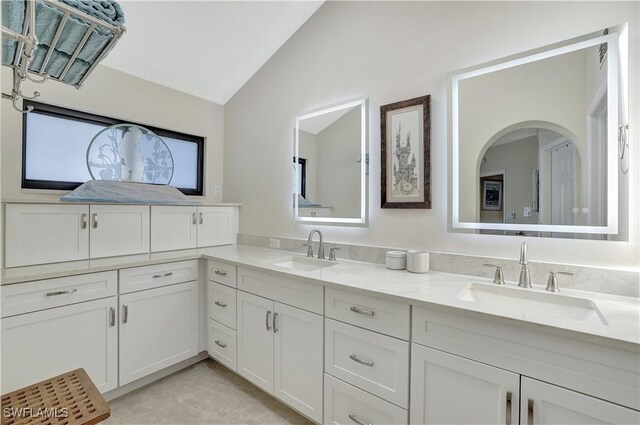 2249 Anchorage Ln Unit B, Naples, FL 34104 - full bathroom with vaulted ceiling and double vanity