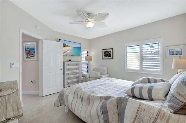 2249 Anchorage Ln Unit B, Naples, FL 34104 - bedroom featuring multiple windows, a ceiling fan, light tile patterned flooring, and baseboards