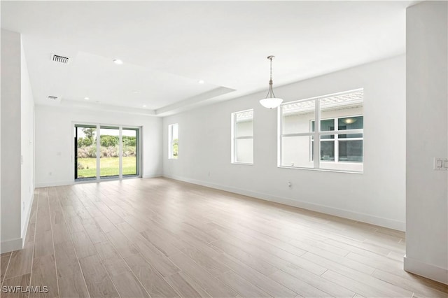 44320 Panther Dr, Punta Gorda, FL 33982 - spare room with light wood-style floors, recessed lighting, and a tray ceiling
