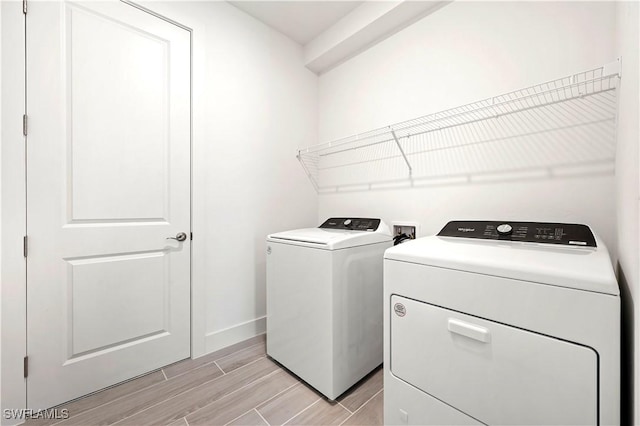 44320 Panther Dr, Punta Gorda, FL 33982 - laundry room with independent washer and dryer and wood finish floors