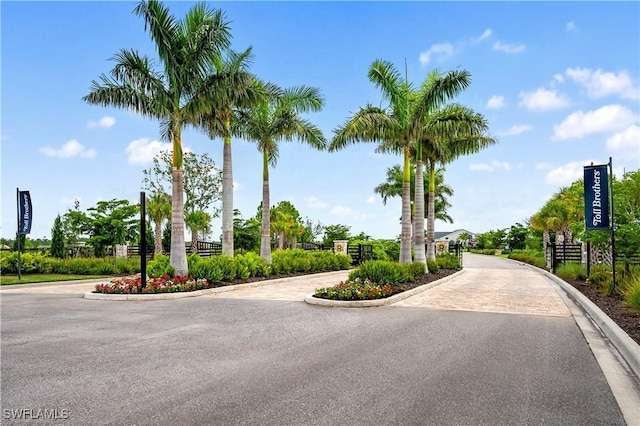 44320 Panther Dr, Punta Gorda, FL 33982 - view of asphalt street featuring curbs and a gated entry
