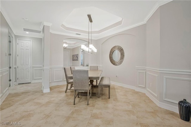 12732 Kinross Ln, Naples, FL 34120 - dining space with a decorative wall, a chandelier, ornamental molding, a raised ceiling, and wainscoting