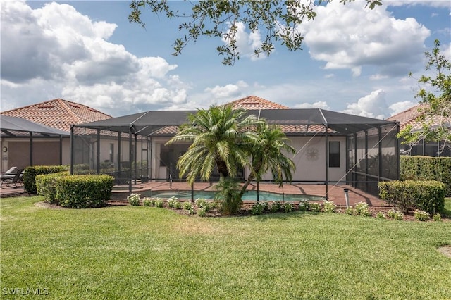 12732 Kinross Ln, Naples, FL 34120 - rear view of house with a tiled roof, a lawn, an outdoor pool, and glass enclosure