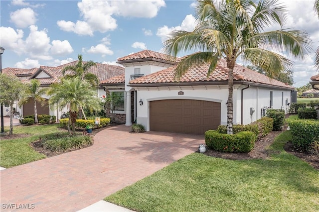 12732 Kinross Ln, Naples, FL 34120 - view of front of property featuring stucco siding, a garage, decorative driveway, a front yard, and a tiled roof
