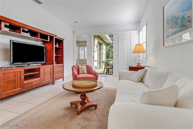 8515 Chase Preserve Dr, Naples, FL 34113 - living area featuring light tile patterned floors and healthy amount of natural light