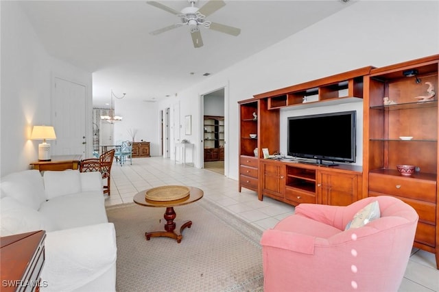 8515 Chase Preserve Dr, Naples, FL 34113 - living room featuring light tile patterned floors, a chandelier, and a ceiling fan