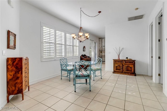 8515 Chase Preserve Dr, Naples, FL 34113 - dining room featuring a chandelier, light tile patterned floors, and baseboards