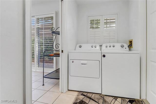 8515 Chase Preserve Dr, Naples, FL 34113 - washroom featuring washing machine and clothes dryer and light tile patterned flooring