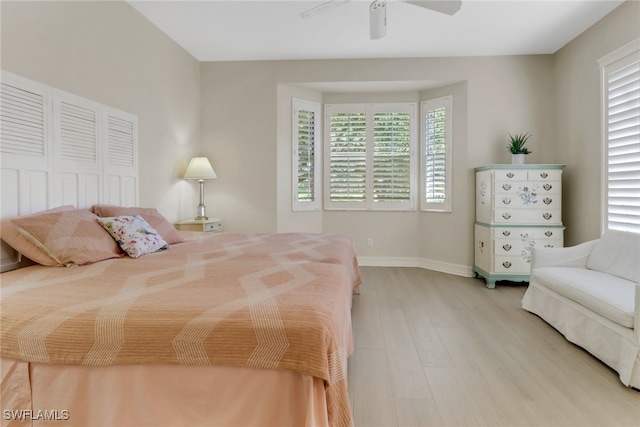 8515 Chase Preserve Dr, Naples, FL 34113 - bedroom featuring light wood finished floors, multiple windows, baseboards, and ceiling fan
