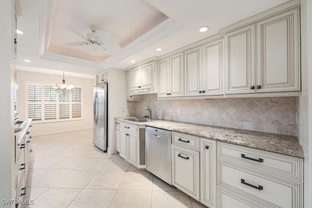 5964 Pelican Bay Blvd Unit 415, Naples, FL 34108 - kitchen featuring appliances with stainless steel finishes, a sink, a chandelier, backsplash, and recessed lighting