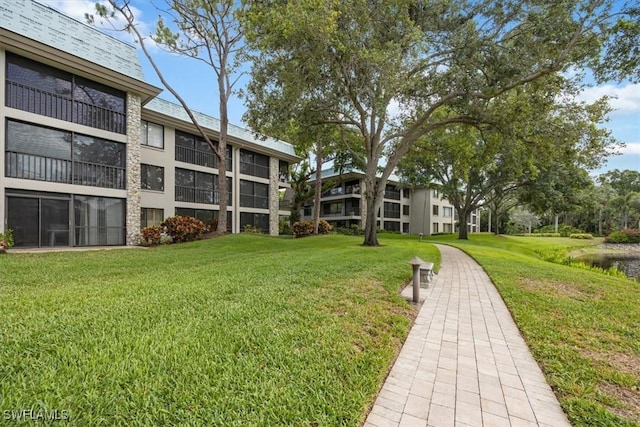 5964 Pelican Bay Blvd Unit 415, Naples, FL 34108 - view of community featuring a yard