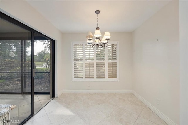 5964 Pelican Bay Blvd Unit 415, Naples, FL 34108 - empty room with a chandelier, light tile patterned floors, and baseboards