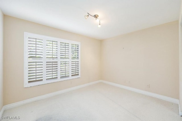 5964 Pelican Bay Blvd Unit 415, Naples, FL 34108 - spare room featuring carpet floors and baseboards