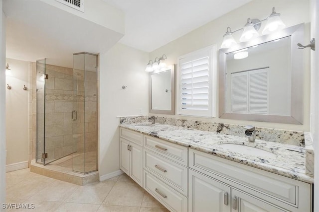 5964 Pelican Bay Blvd Unit 415, Naples, FL 34108 - full bathroom with double vanity, a stall shower, tile patterned flooring, and baseboards