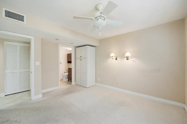 5964 Pelican Bay Blvd Unit 415, Naples, FL 34108 - unfurnished bedroom with light colored carpet, baseboards, and connected bathroom