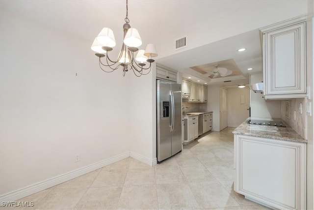5964 Pelican Bay Blvd Unit 415, Naples, FL 34108 - kitchen featuring appliances with stainless steel finishes, a raised ceiling, a chandelier, under cabinet range hood, and baseboards