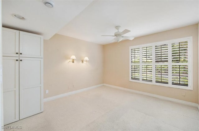 5964 Pelican Bay Blvd Unit 415, Naples, FL 34108 - unfurnished bedroom with light carpet, baseboards, and ceiling fan