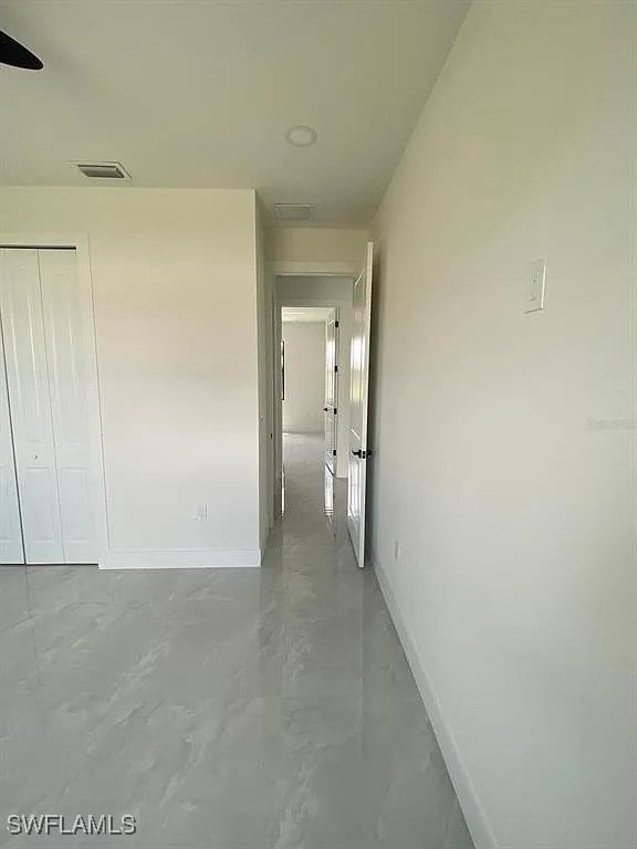 3017 4th St W, Lehigh Acres, FL 33971 - corridor featuring baseboards and concrete flooring