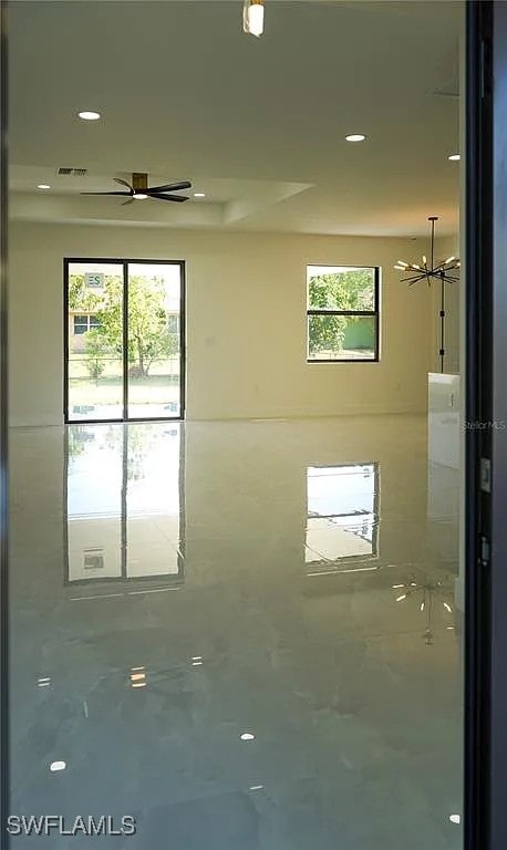 3017 4th St W, Lehigh Acres, FL 33971 - spare room featuring a chandelier, recessed lighting, and a ceiling fan