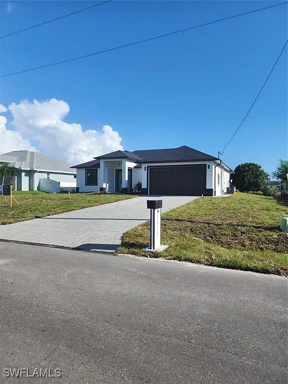 3017 4th St W, Lehigh Acres, FL 33971 - single story home featuring an attached garage, a front lawn, and driveway