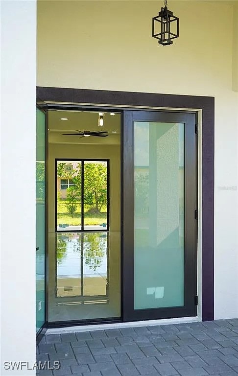 3017 4th St W, Lehigh Acres, FL 33971 - doorway to property with stucco siding