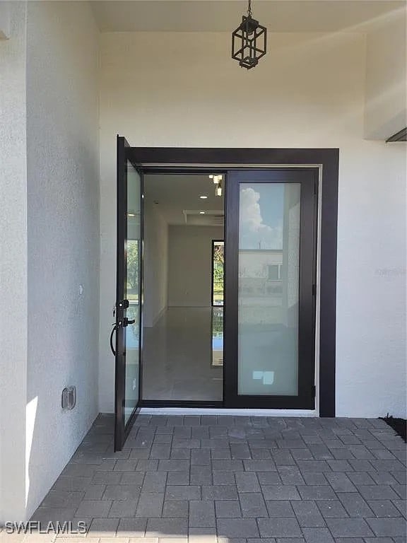 3017 4th St W, Lehigh Acres, FL 33971 - entrance to property with stucco siding