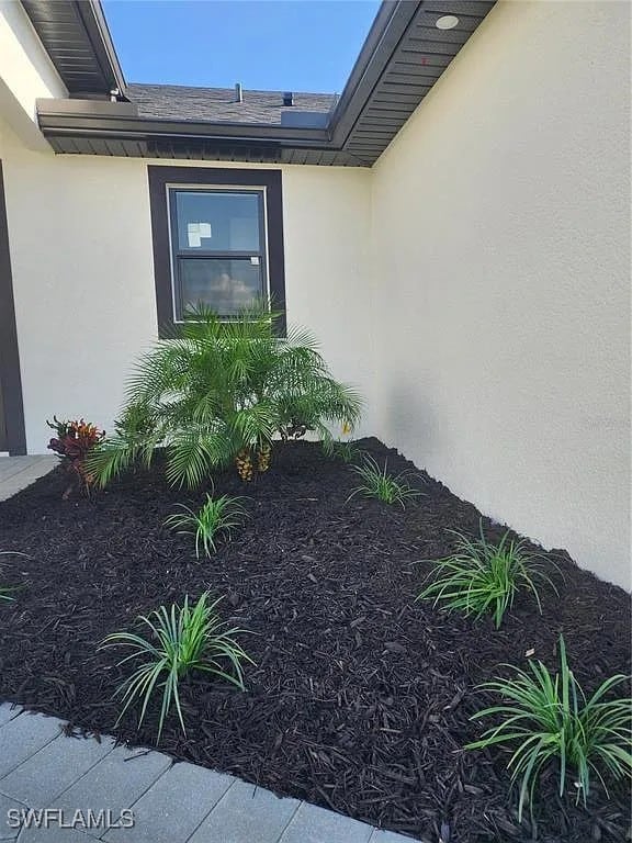 3017 4th St W, Lehigh Acres, FL 33971 - view of exterior entry featuring stucco siding