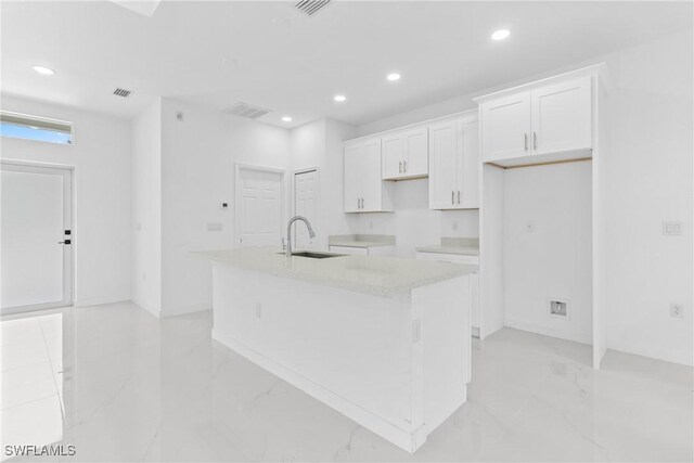 3507 41st St SW, Lehigh Acres, FL 33976 - kitchen with a sink, light marble finish floors, an island with sink, white cabinets, and recessed lighting