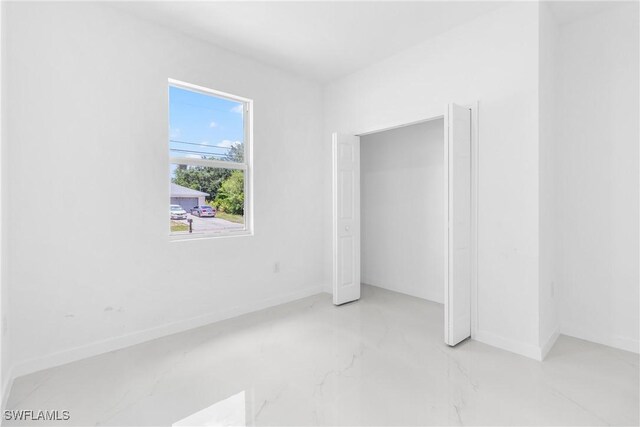 3507 41st St SW, Lehigh Acres, FL 33976 - unfurnished bedroom featuring baseboards and marble finish floors