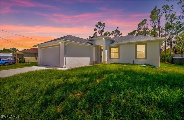 3507 41st St SW, Lehigh Acres, FL 33976 - view of front of house featuring a garage, concrete driveway, stucco siding, and a front yard