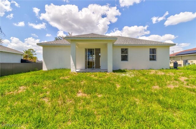 3507 41st St SW, Lehigh Acres, FL 33976 - back of property with stucco siding and a shingled roof