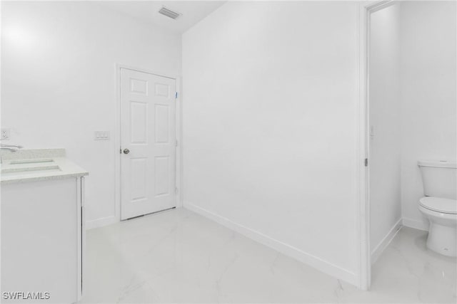 3507 41st St SW, Lehigh Acres, FL 33976 - bathroom featuring marble finish floors, toilet, baseboards, and double vanity