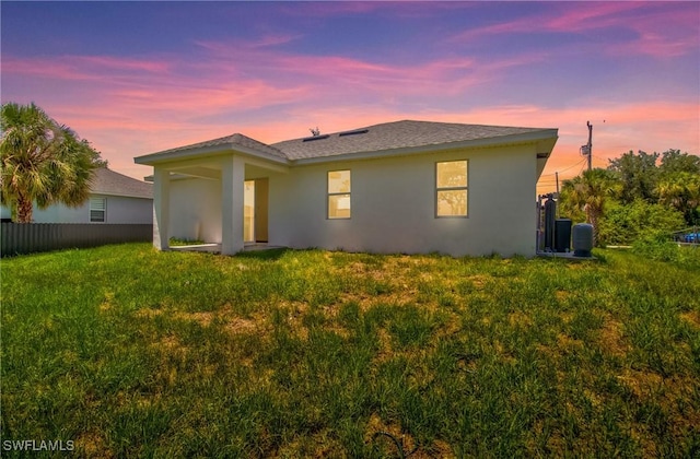 3507 41st St SW, Lehigh Acres, FL 33976 - back of house with stucco siding and central AC unit