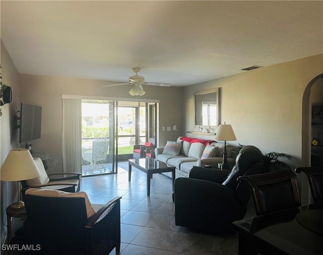 11460 Caravel Cir Unit 5009, Fort Myers, FL 33908 - living room with arched walkways, ceiling fan, and light tile patterned flooring